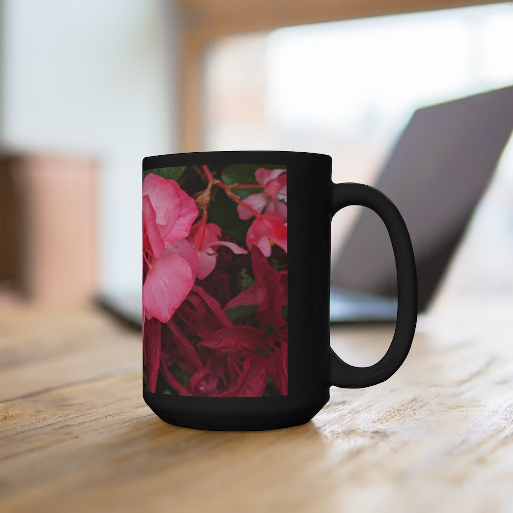 A stylish black ceramic mug featuring pink flowers design, perfect for coffee and tea lovers, with a comfortable C-handle.