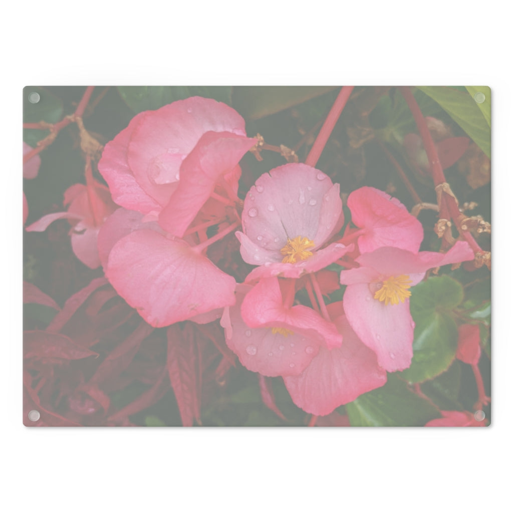 A stylish Pink Flowers Cutting Board made of tempered glass with a floral design and rubber dots for stability.