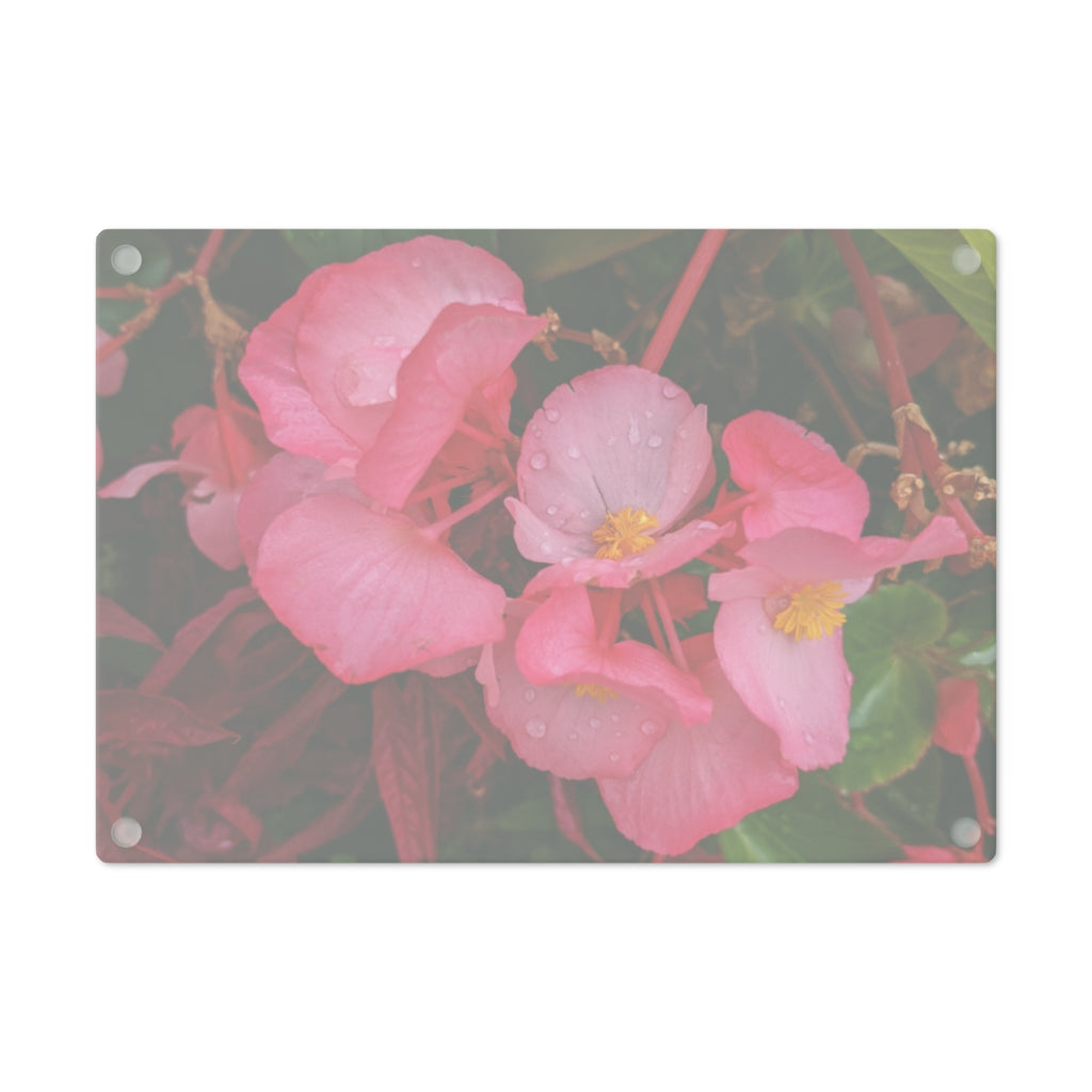 A stylish Pink Flowers Cutting Board made of tempered glass with a floral design and rubber dots for stability.