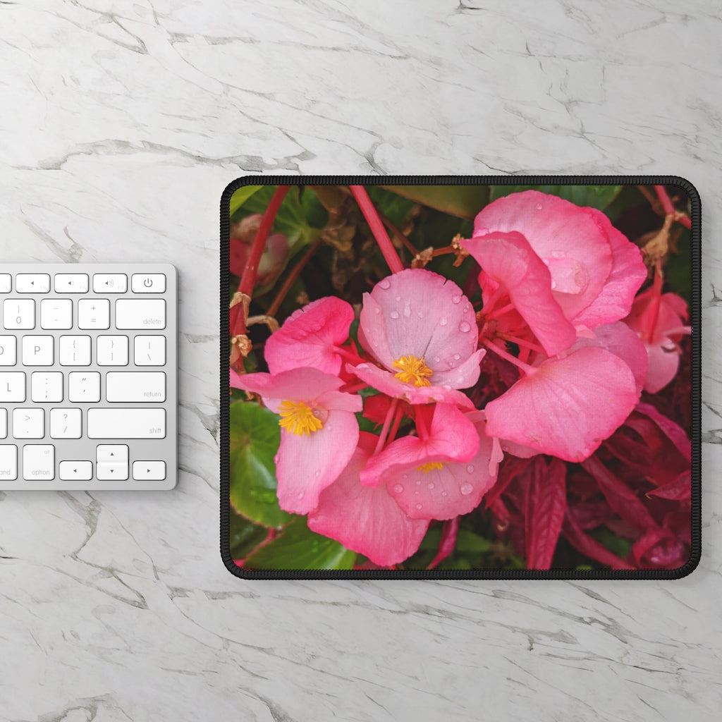 A vibrant pink flowers gaming mouse pad with stitched edges, designed for smooth mouse movement and durability.