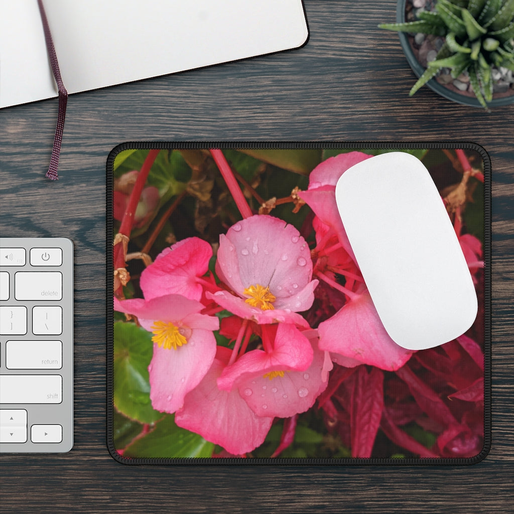 A vibrant pink flowers gaming mouse pad with stitched edges, designed for smooth mouse movement and durability.