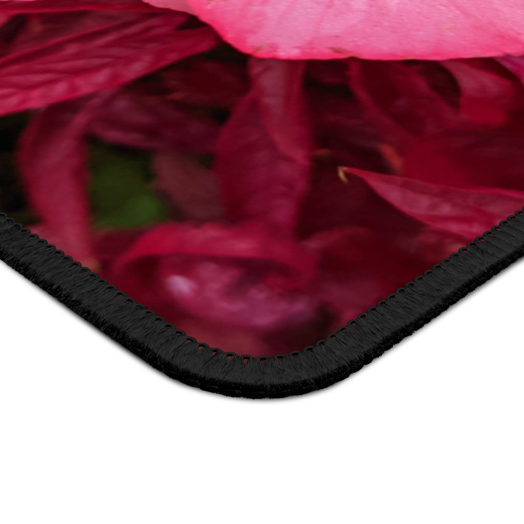 A vibrant pink flowers gaming mouse pad with stitched edges, designed for smooth mouse movement and durability.