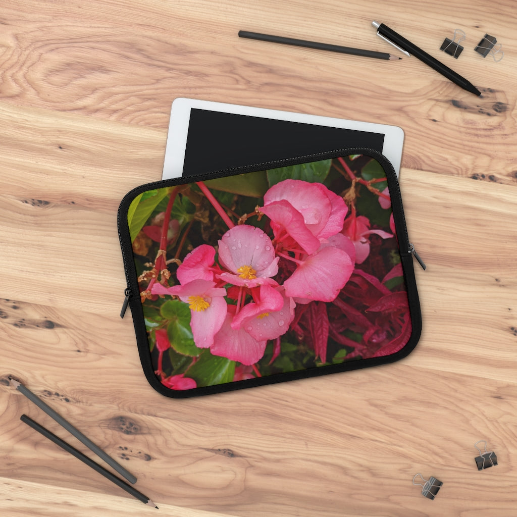 A stylish pink flowers laptop sleeve with a black polyester back, featuring dual zipper enclosures and a water-resistant design.