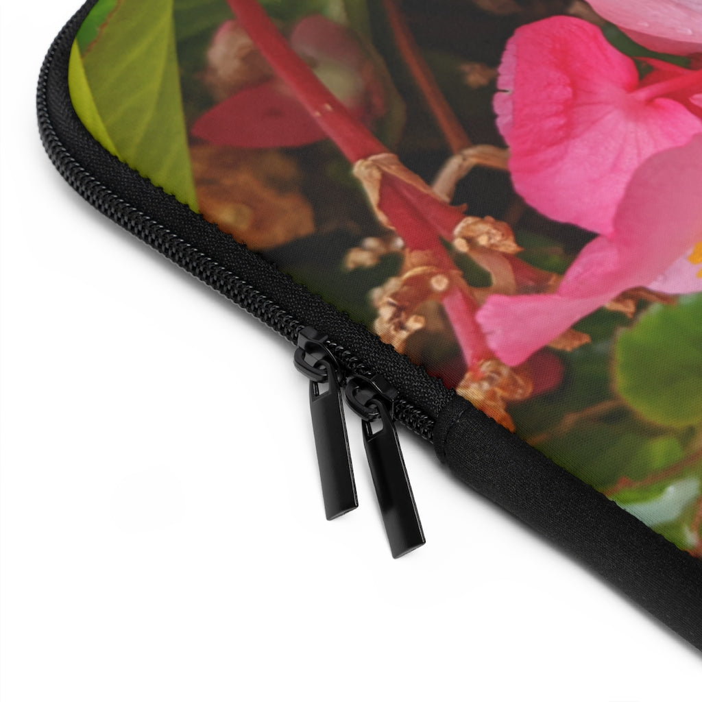 A stylish pink flowers laptop sleeve with a black polyester back, featuring dual zipper enclosures and a water-resistant design.