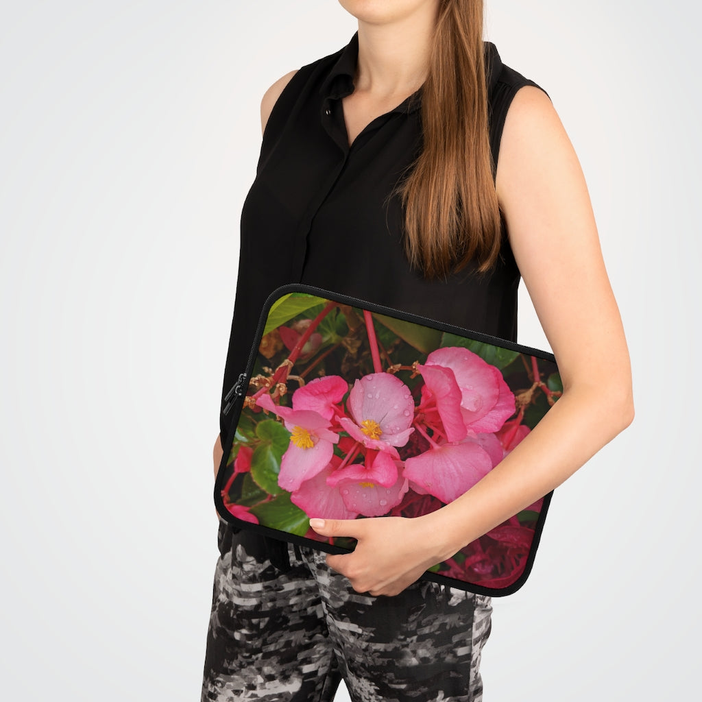 A stylish pink flowers laptop sleeve with a black polyester back, featuring dual zipper enclosures and a water-resistant design.