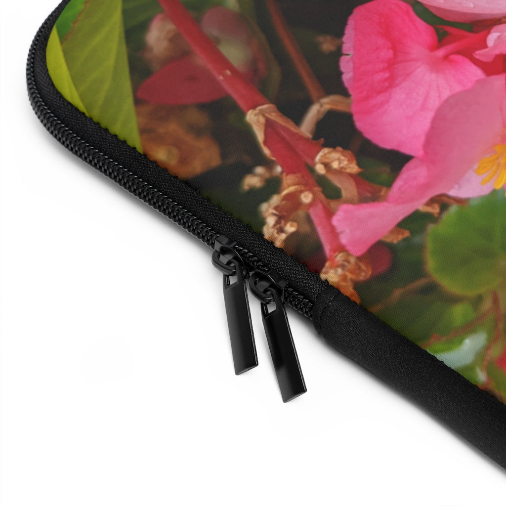 A stylish pink flowers laptop sleeve with a black polyester back, featuring dual zipper enclosures and a water-resistant design.