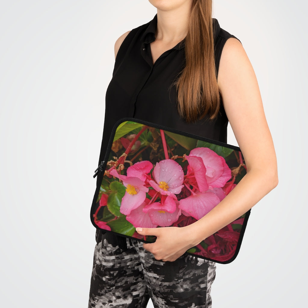 A stylish pink flowers laptop sleeve with a black polyester back, featuring dual zipper enclosures and a water-resistant design.