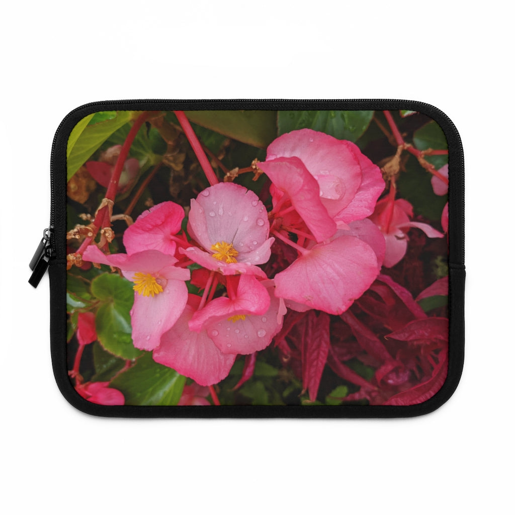 A stylish pink flowers laptop sleeve with a black polyester back, featuring dual zipper enclosures and a water-resistant design.