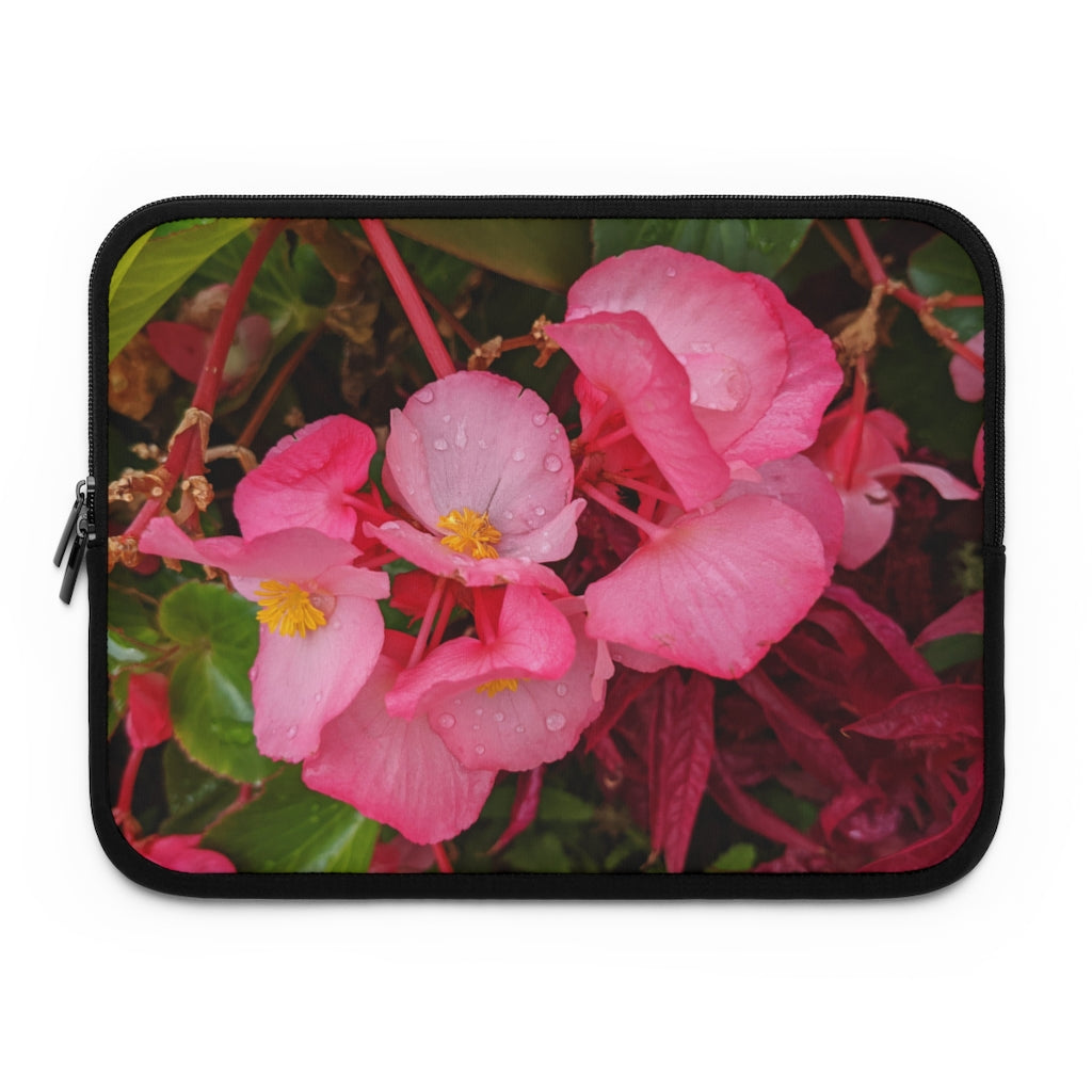 A stylish pink flowers laptop sleeve with a black polyester back, featuring dual zipper enclosures and a water-resistant design.