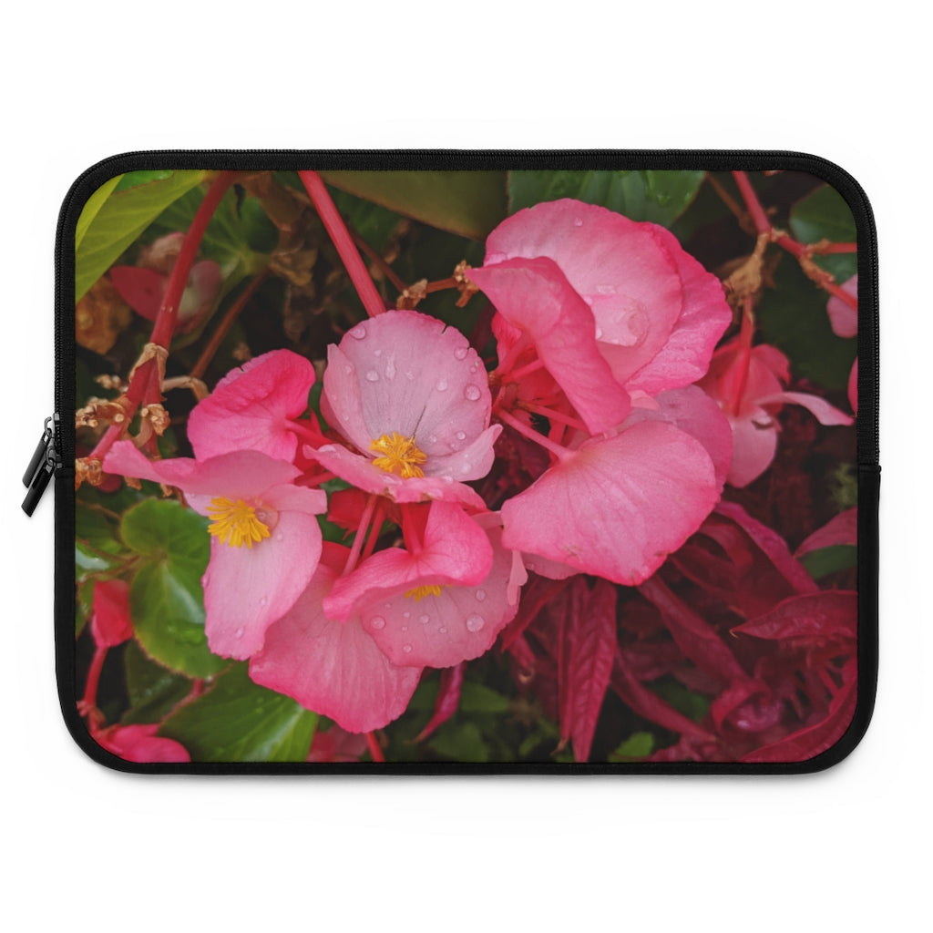 A stylish pink flowers laptop sleeve with a black polyester back, featuring dual zipper enclosures and a water-resistant design.