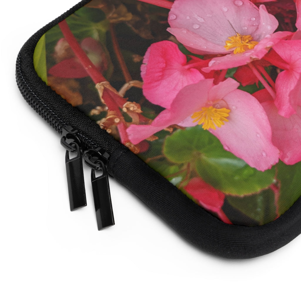 A stylish pink flowers laptop sleeve with a black polyester back, featuring dual zipper enclosures and a water-resistant design.