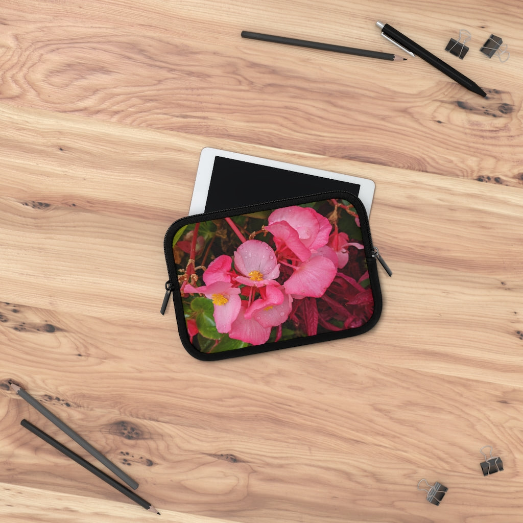 A stylish pink flowers laptop sleeve with a black polyester back, featuring dual zipper enclosures and a water-resistant design.