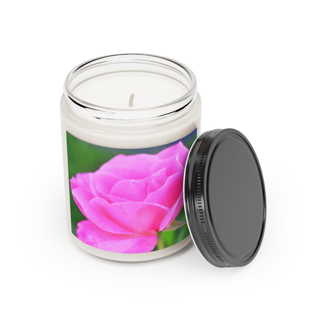 A beautifully crafted Pink Flowers Scented Candle in a glass container, showcasing its vibrant color and elegant design.