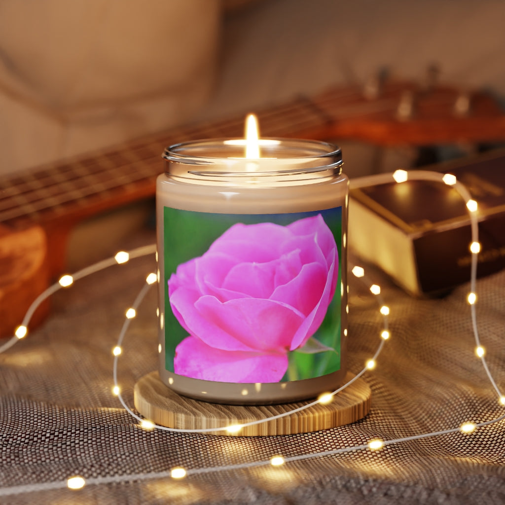 A beautifully crafted Pink Flowers Scented Candle in a glass container, showcasing its vibrant color and elegant design.