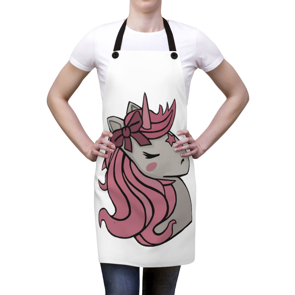 A vibrant pink apron featuring a whimsical unicorn head design, perfect for cooking and backyard gatherings.