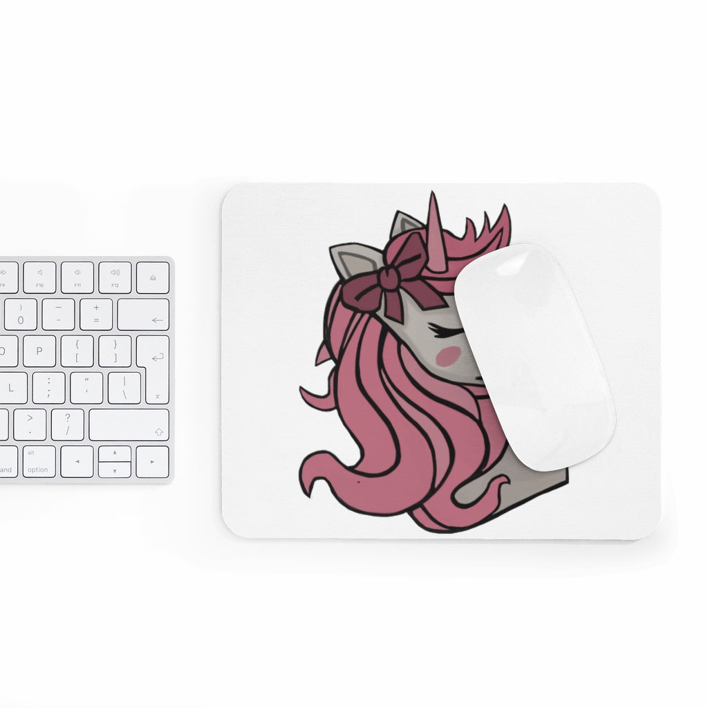 A colorful mouse pad featuring a pink-haired unicorn design, perfect for adding charm to any desk.