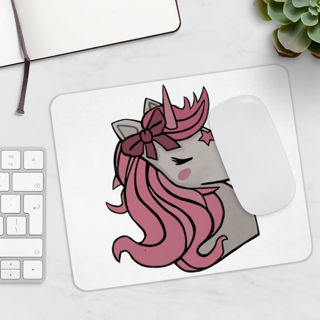 A colorful mouse pad featuring a pink-haired unicorn design, perfect for adding charm to any desk.