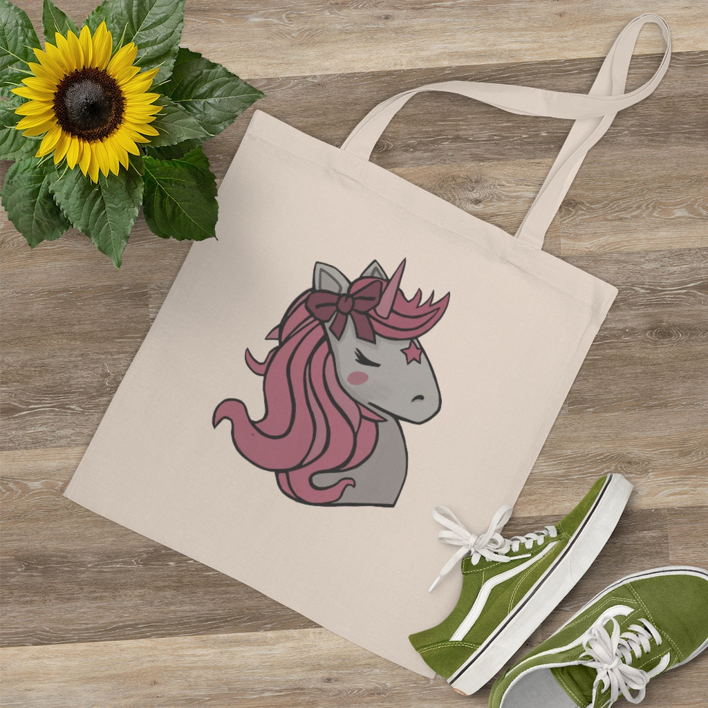 A stylish Pink Hair Unicorn Tote Bag made of 100% cotton with long handles and a vibrant unicorn design.