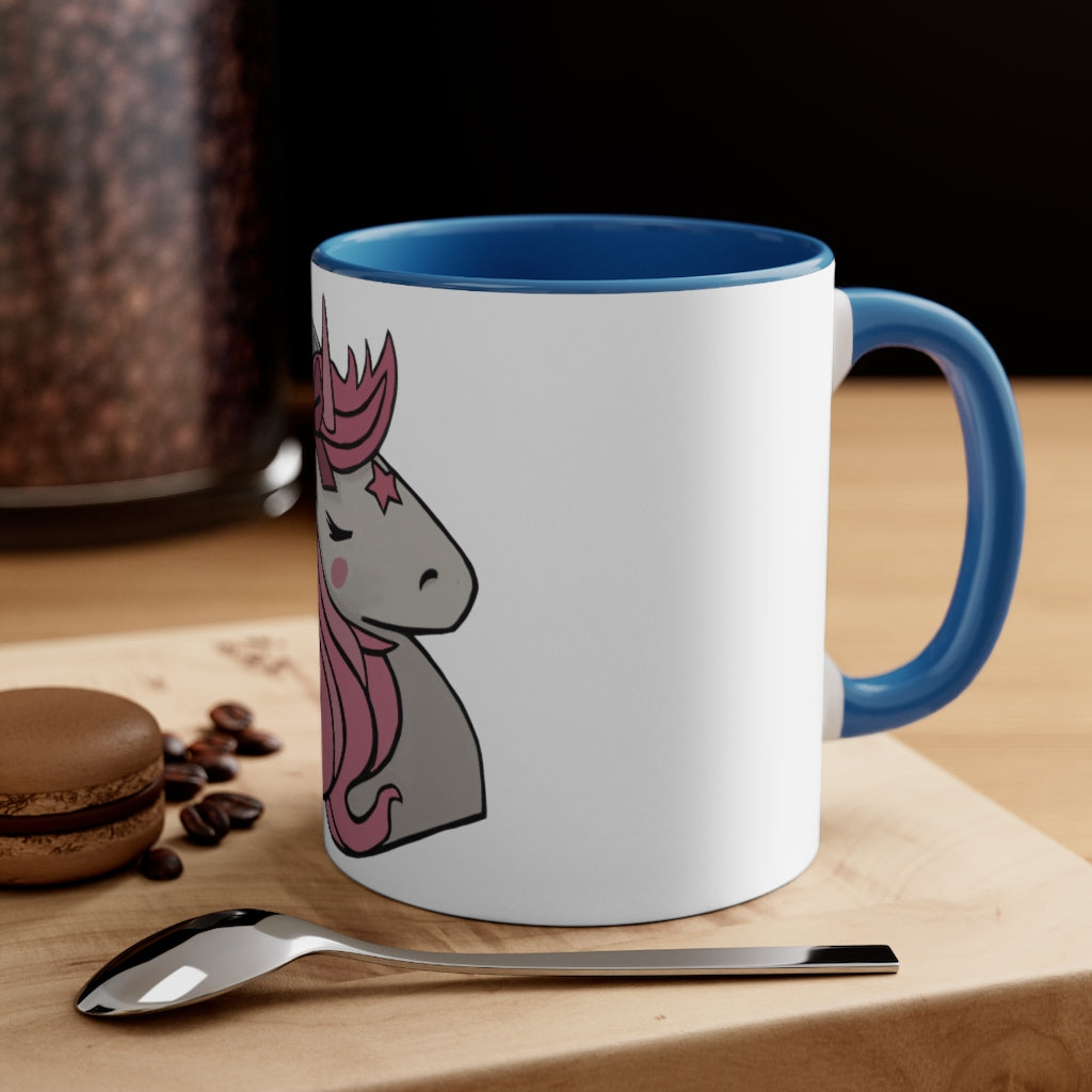 A vibrant pink unicorn accent coffee mug with a white exterior and pink interior, featuring a comfortable C-handle for easy gripping.