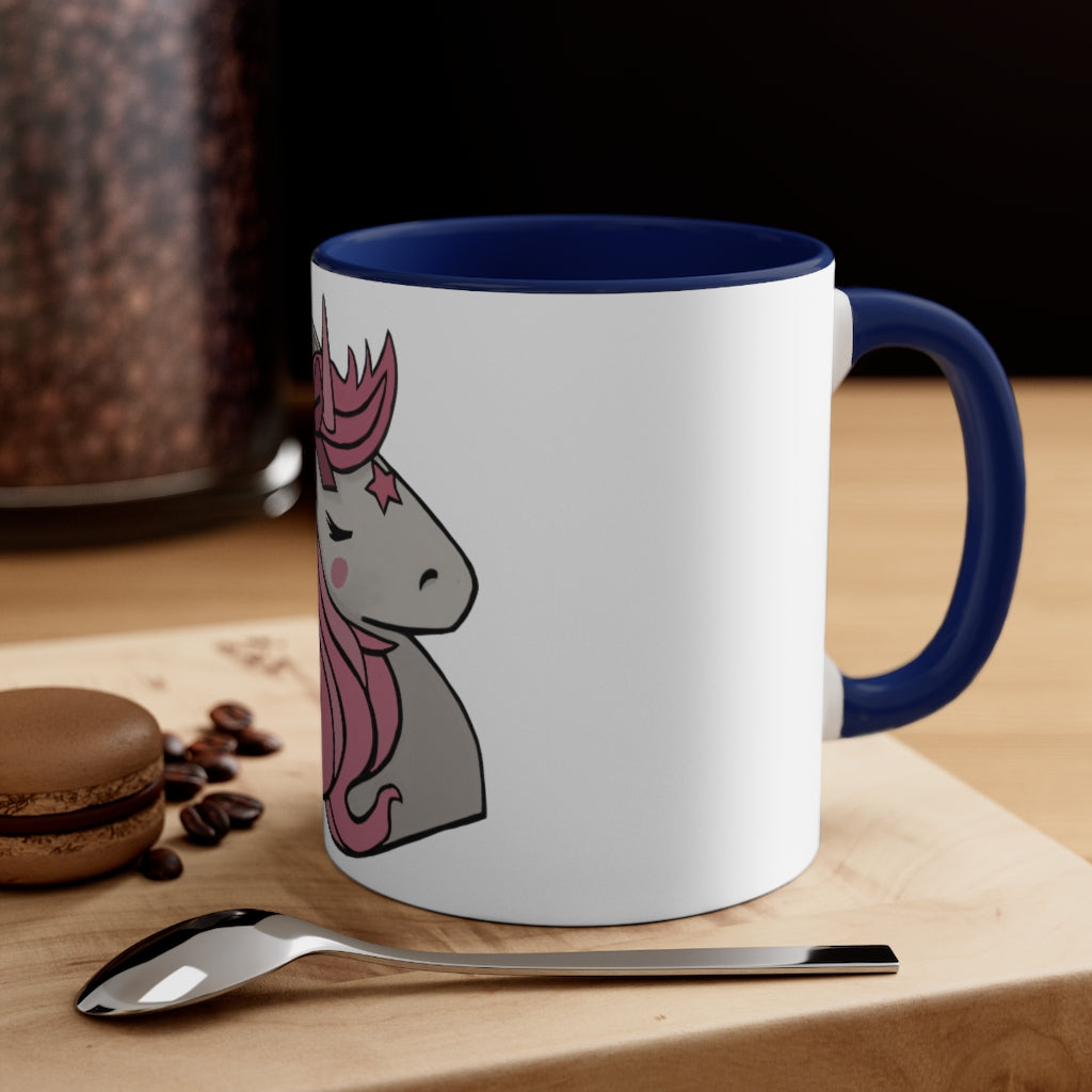 A vibrant pink unicorn accent coffee mug with a white exterior and pink interior, featuring a comfortable C-handle for easy gripping.