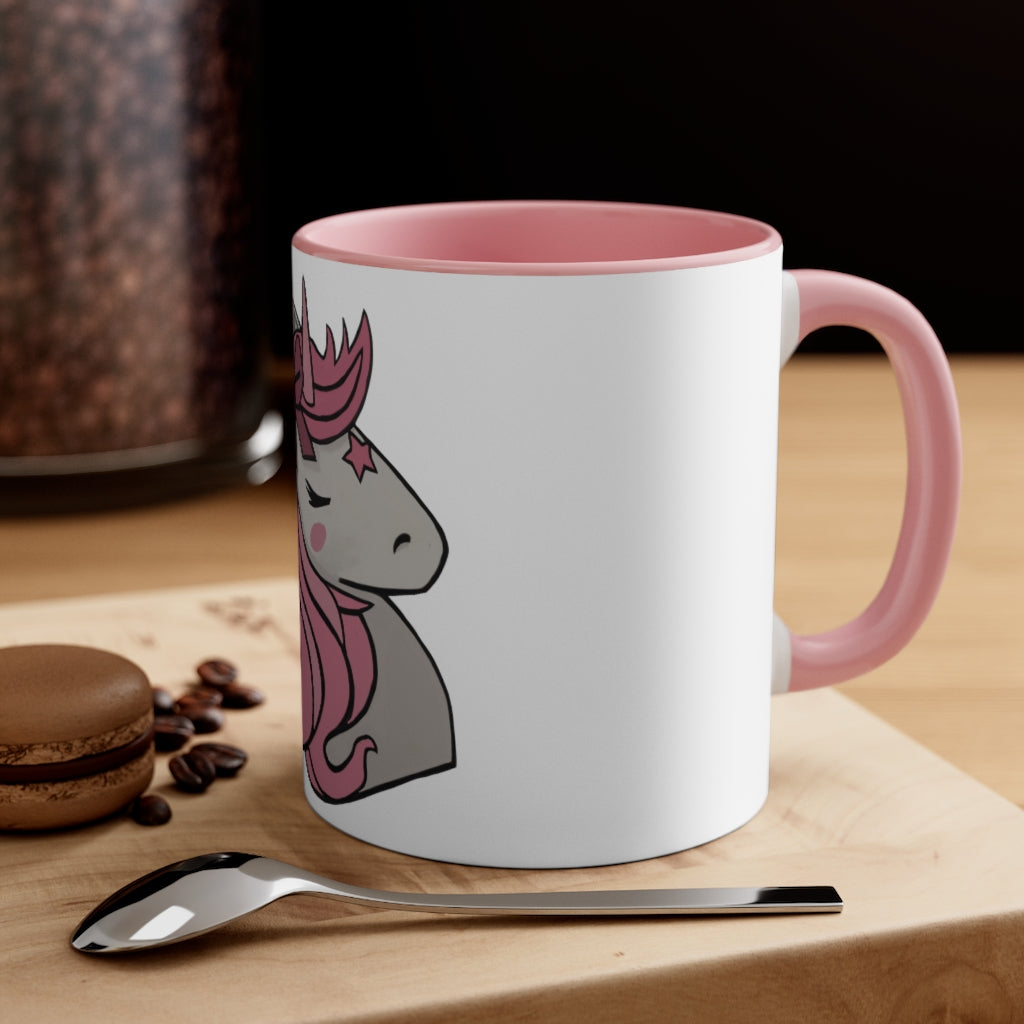 A vibrant pink unicorn accent coffee mug with a white exterior and pink interior, featuring a comfortable C-handle for easy gripping.