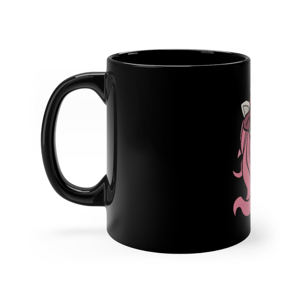 A stylish black ceramic mug featuring a vibrant pink unicorn design, perfect for coffee or tea.