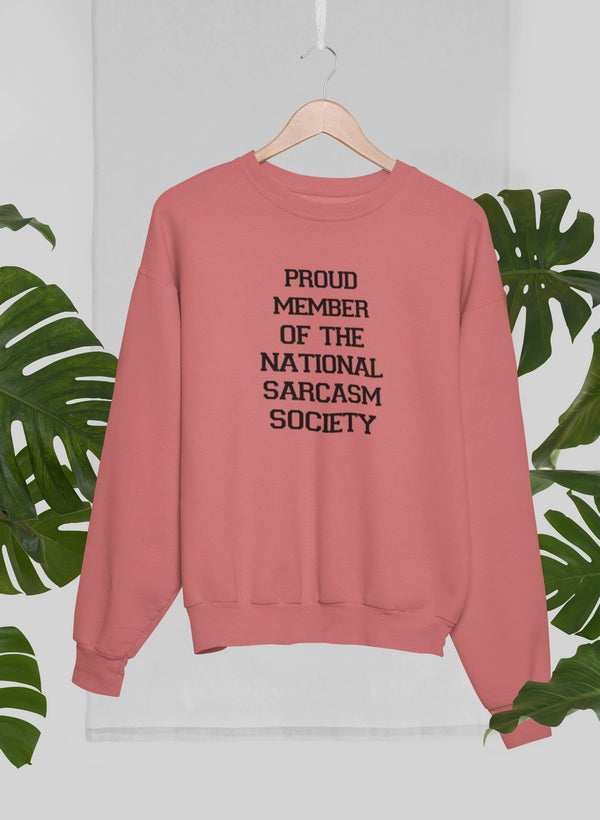 A cozy sweatshirt featuring the phrase 'Proud Member Of The National Sarcasm Society' in bold print, made from soft cotton.