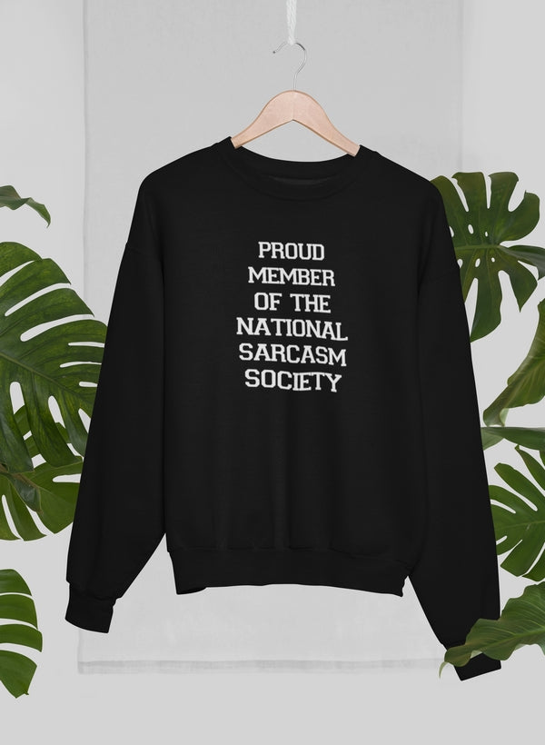 A cozy sweatshirt featuring the phrase 'Proud Member Of The National Sarcasm Society' in bold print, made from soft cotton.