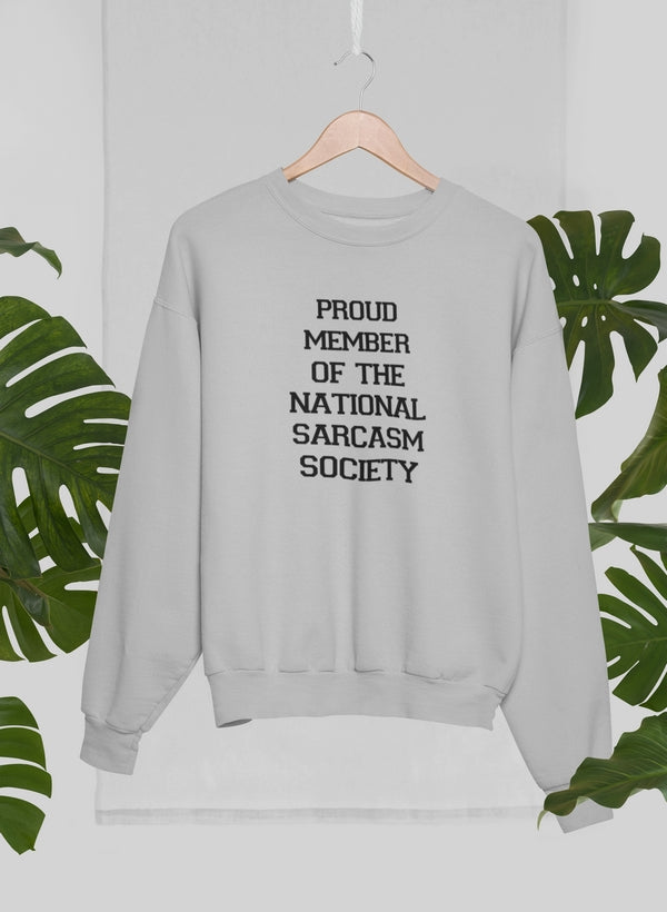 A cozy sweatshirt featuring the phrase 'Proud Member Of The National Sarcasm Society' in bold print, made from soft cotton.