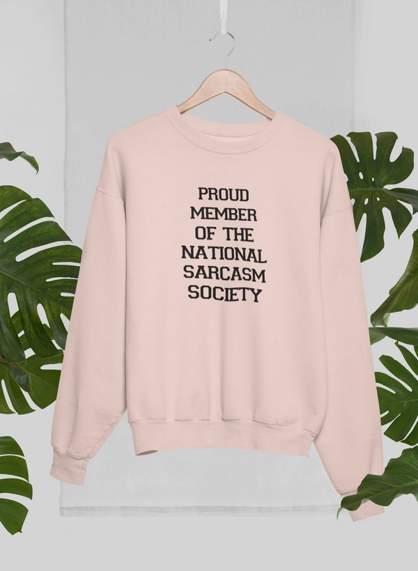 A cozy sweatshirt featuring the phrase 'Proud Member Of The National Sarcasm Society' in bold print, made from soft cotton.