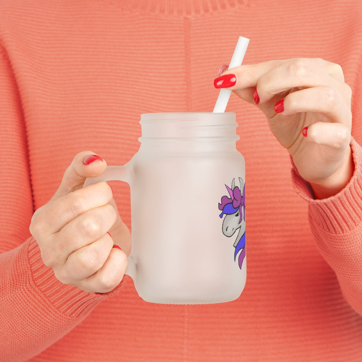 A frosted glass mason jar featuring a vibrant purple and blue unicorn design, complete with a straw and lid, perfect for personalized drinks.