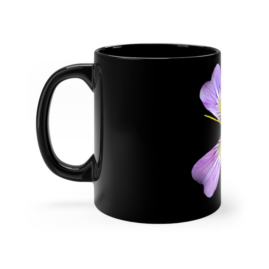 A stylish 11oz black ceramic mug featuring a vibrant purple flower design, perfect for coffee or tea.