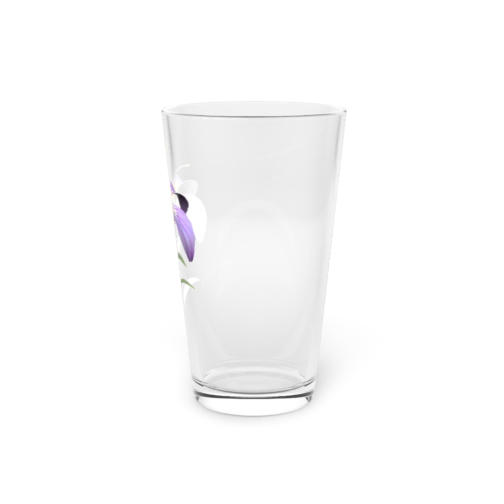 A clear 16oz pint glass featuring a beautiful purple flower design, perfect for beverages.