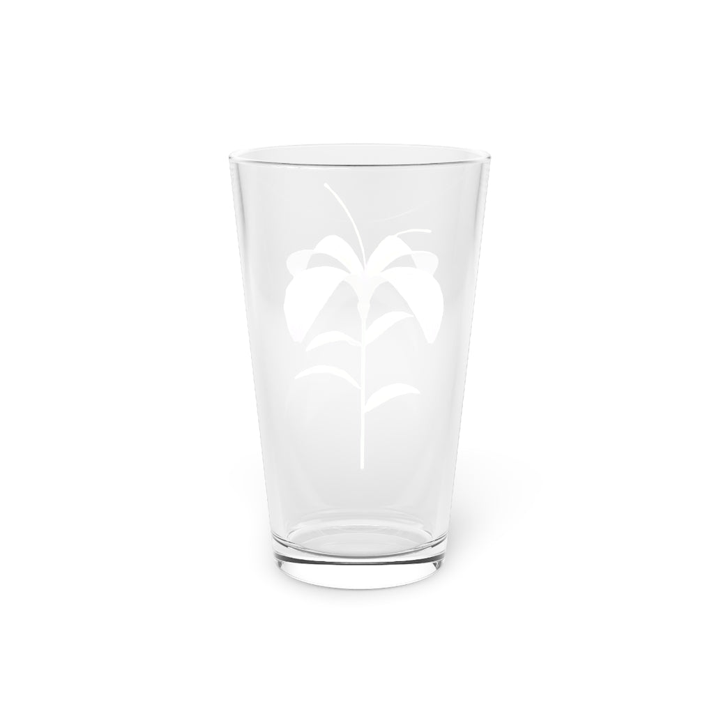 A clear 16oz pint glass featuring a beautiful purple flower design, perfect for beverages.