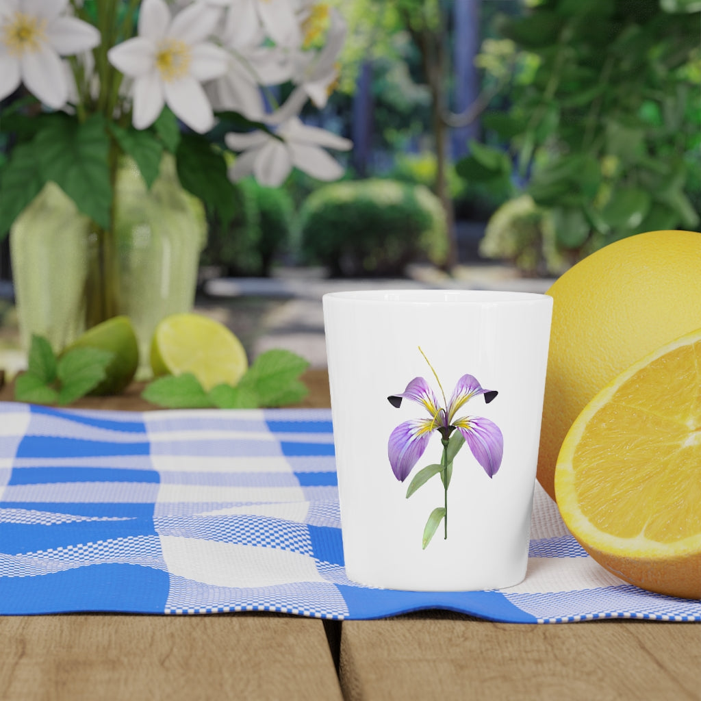 A personalized Purple Flower Shot Glass with a ceramic finish, featuring a vibrant purple floral design and available with a white or black interior.