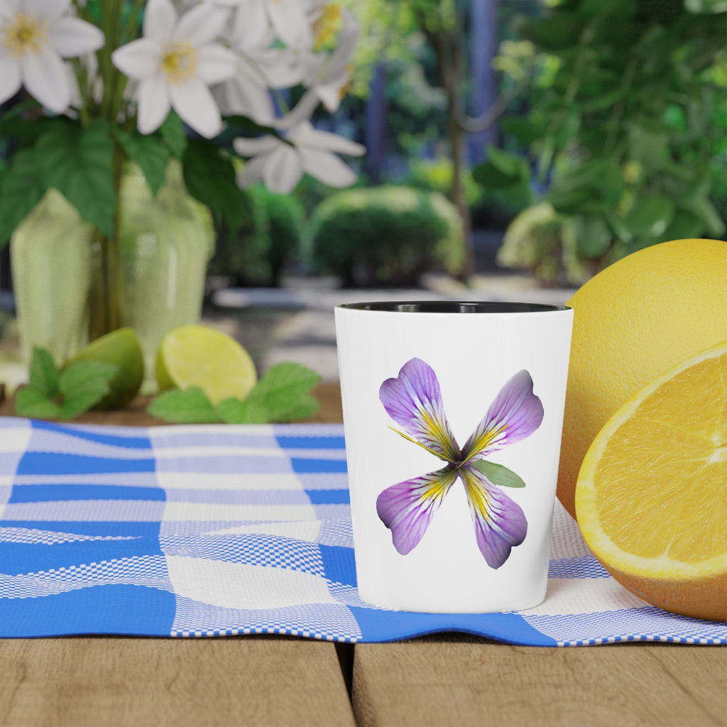 A personalized Purple Flower Shot Glass with a white ceramic finish and a black interior, showcasing its elegant design.