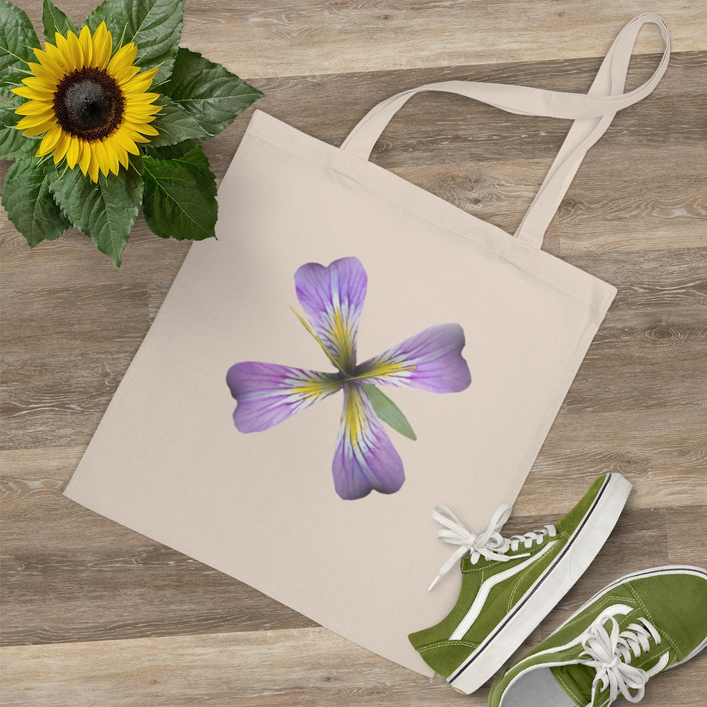 A stylish purple flower tote bag made of 100% cotton with long handles and cross stitching for added durability.