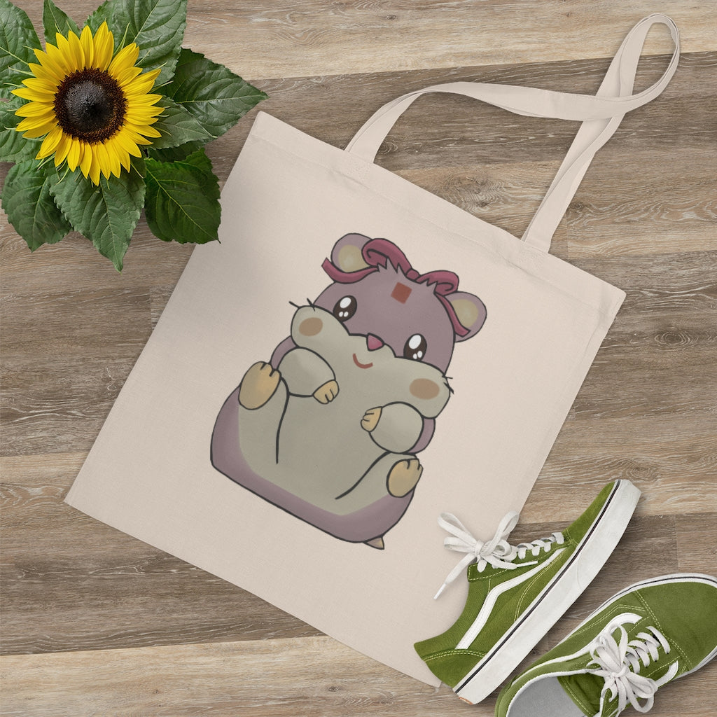 A vibrant Purple Hamster Tote Bag made of 100% cotton, featuring long cross-stitched handles for durability and a colorful design.