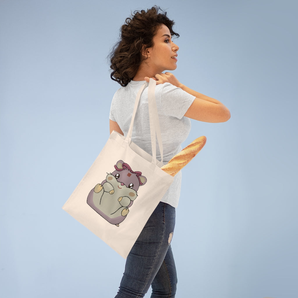 A vibrant Purple Hamster Tote Bag made of 100% cotton, featuring long cross-stitched handles for durability and a colorful design.