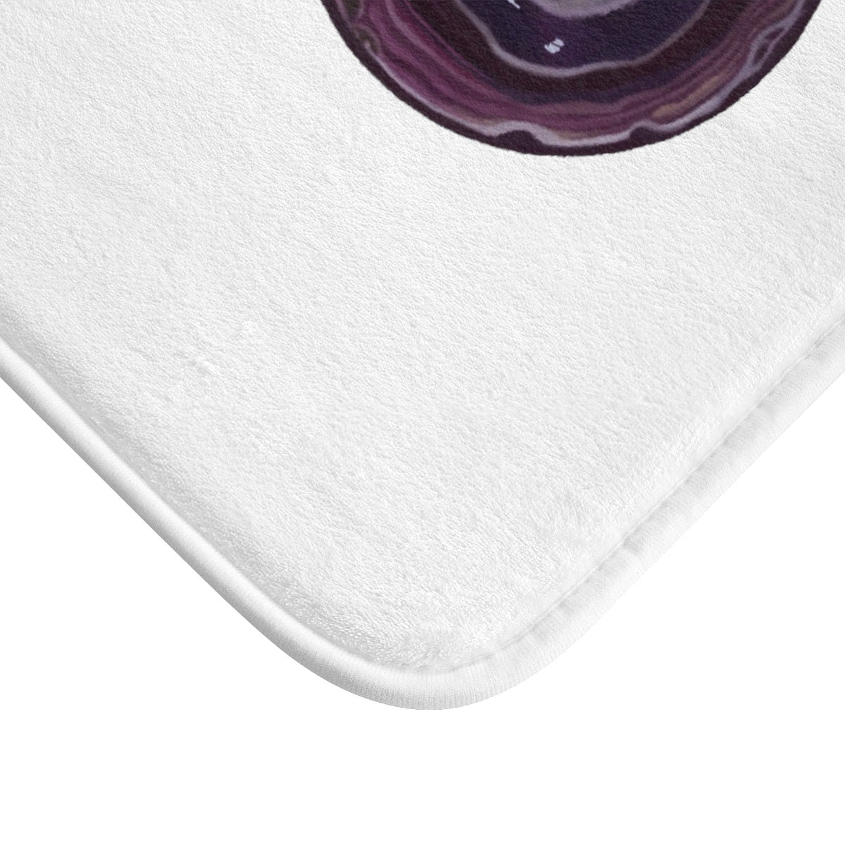 Purple Rock Bath Mat featuring a stylish design with anti-slip backing, made of soft microfiber material.