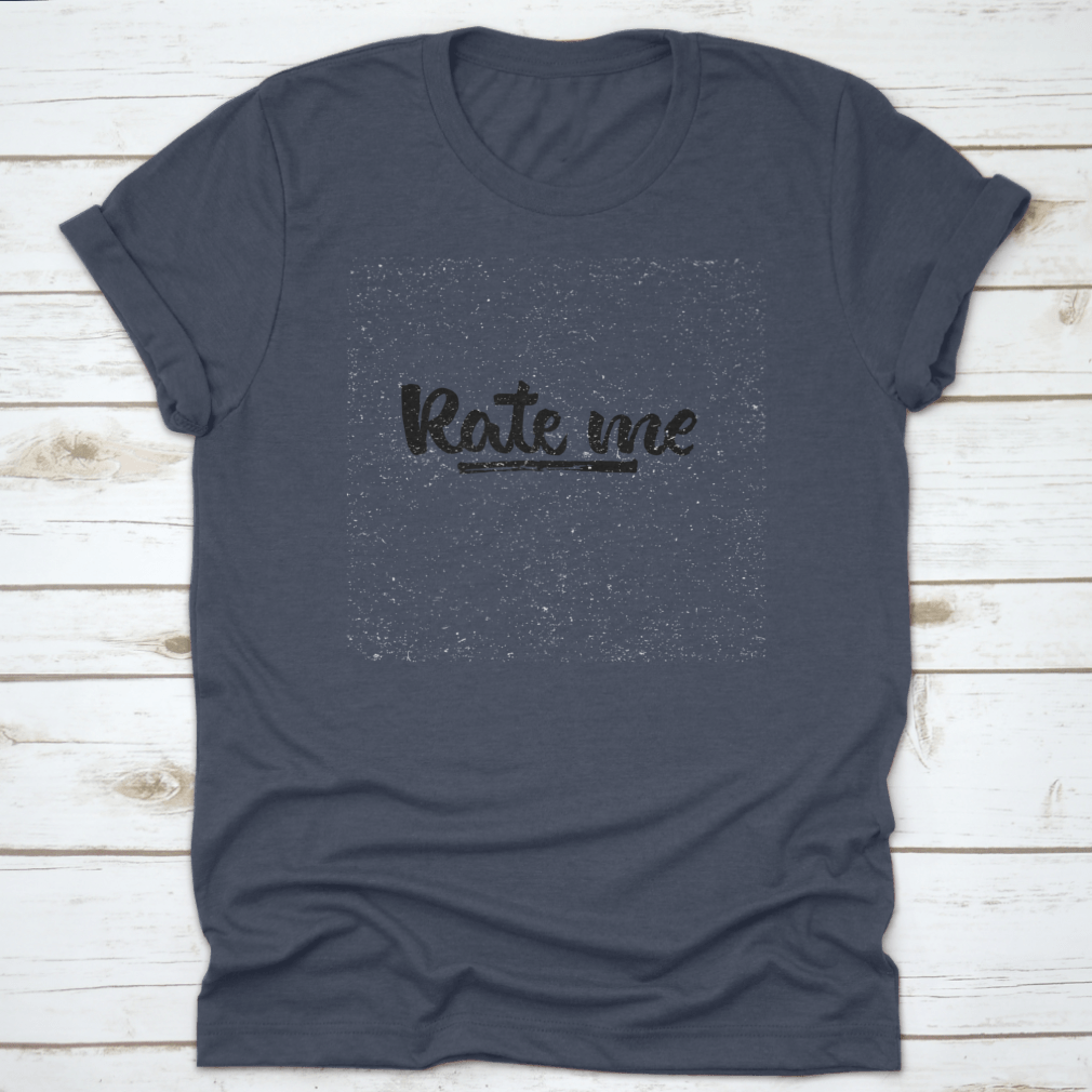 A stylish t-shirt featuring modern brush calligraphy design with the words 'Rate Me. Ink Hand Lettering' on a soft cotton fabric.