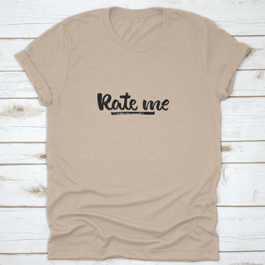 A stylish t-shirt featuring modern brush calligraphy design with the words 'Rate Me. Ink Hand Lettering' on a soft cotton fabric.