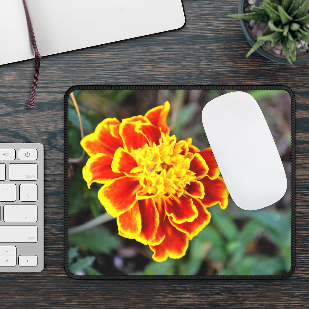 A vibrant red and yellow flower gaming mouse pad with stitched edges, designed for smooth mouse movement.