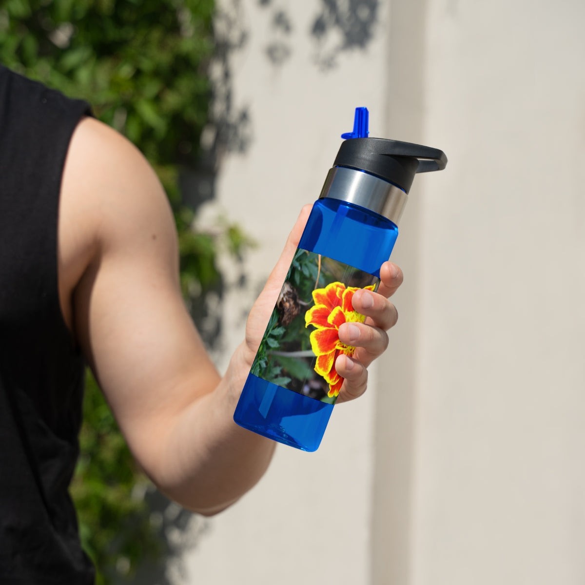 Red and yellow flower design Tritan sport bottle with a carabiner hook and straw lid, perfect for hydration on the go.