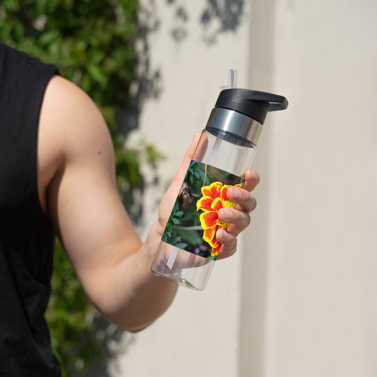 Red and yellow flower design Tritan sport bottle with a carabiner hook and straw lid, perfect for hydration on the go.