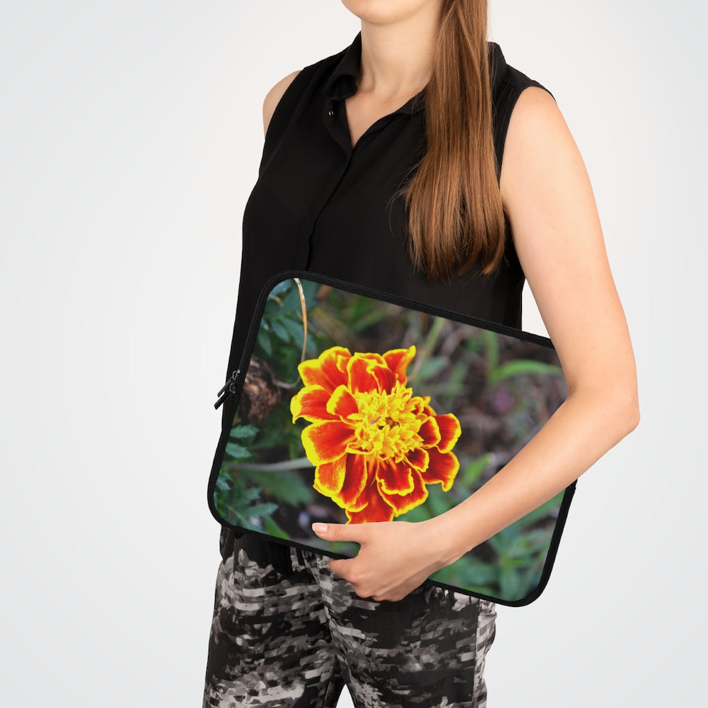 A vibrant red and yellow flower laptop sleeve with a black polyester back, featuring dual zipper enclosures and a smooth neoprene material.