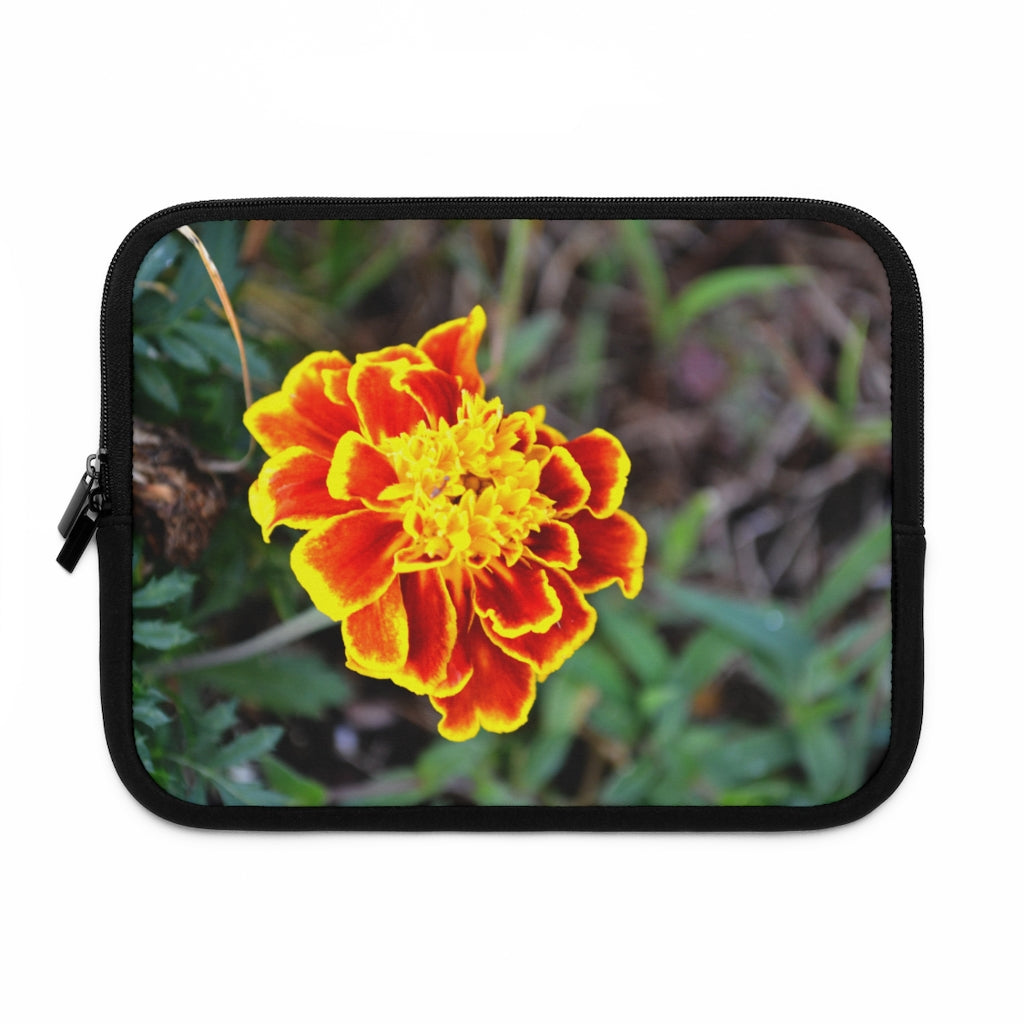 A vibrant red and yellow flower laptop sleeve with a black polyester back, featuring dual zipper enclosures and a smooth neoprene material.