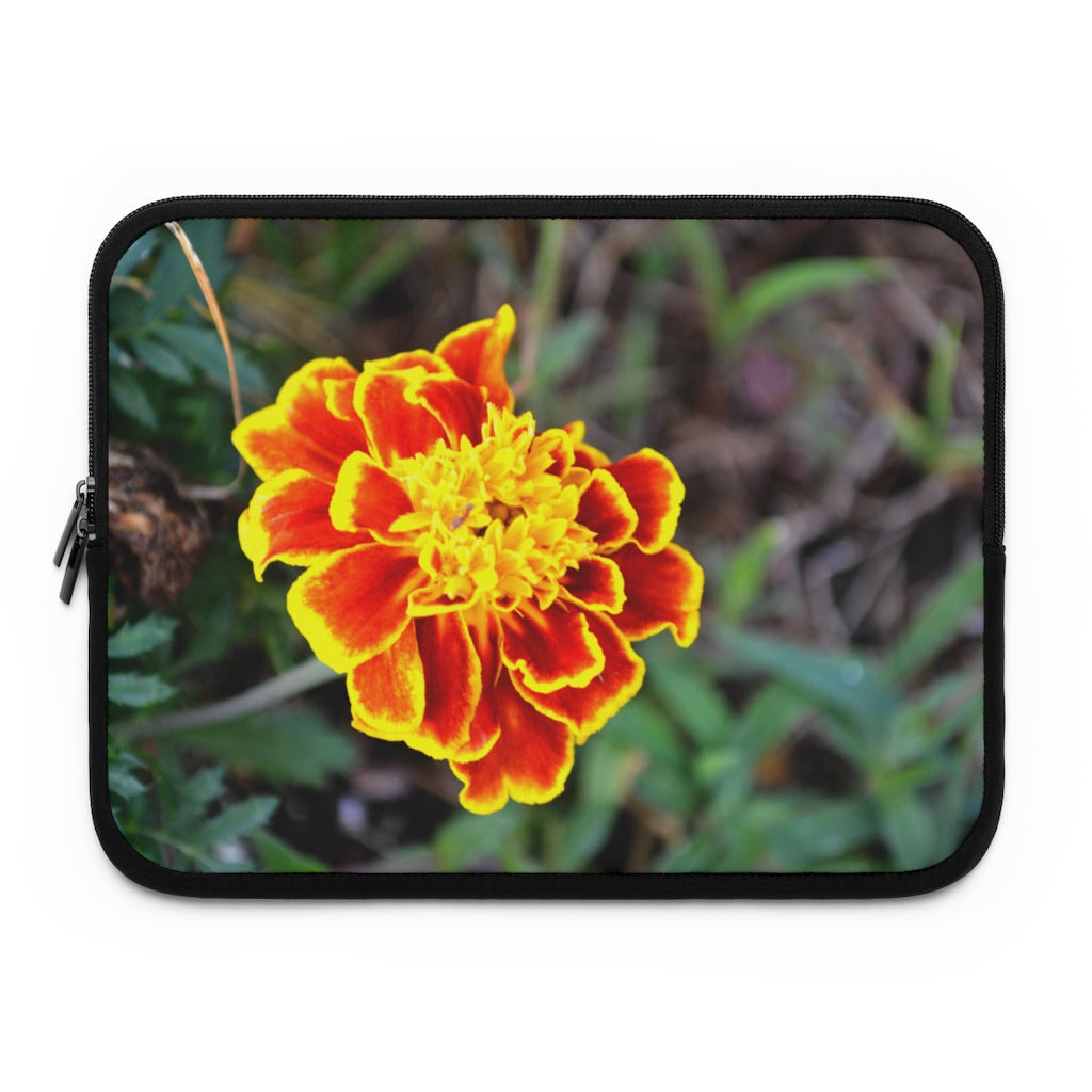 A vibrant red and yellow flower laptop sleeve with a black polyester back, featuring dual zipper enclosures and a smooth neoprene material.