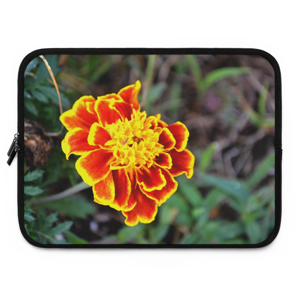 A vibrant red and yellow flower laptop sleeve with a black polyester back, featuring dual zipper enclosures and a smooth neoprene material.