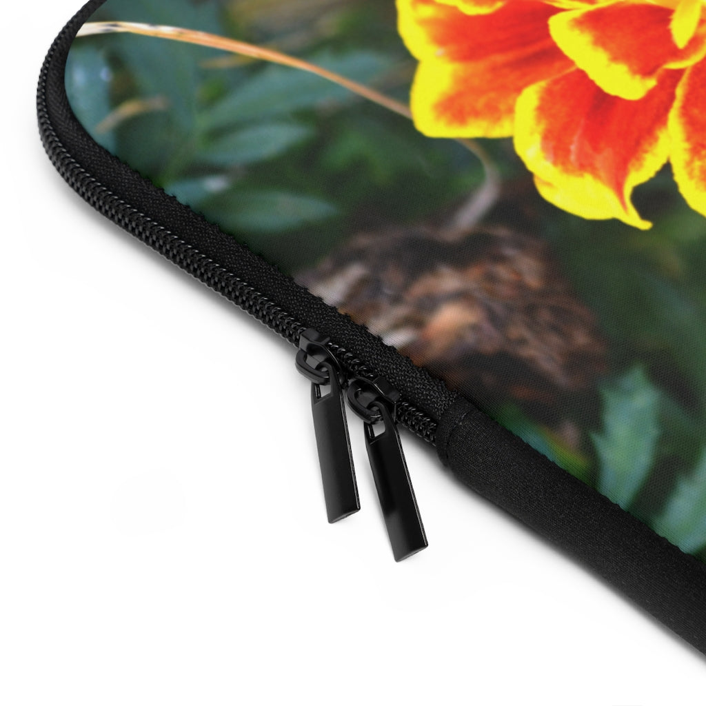 A vibrant red and yellow flower laptop sleeve with a black polyester back, featuring dual zipper enclosures and a smooth neoprene material.